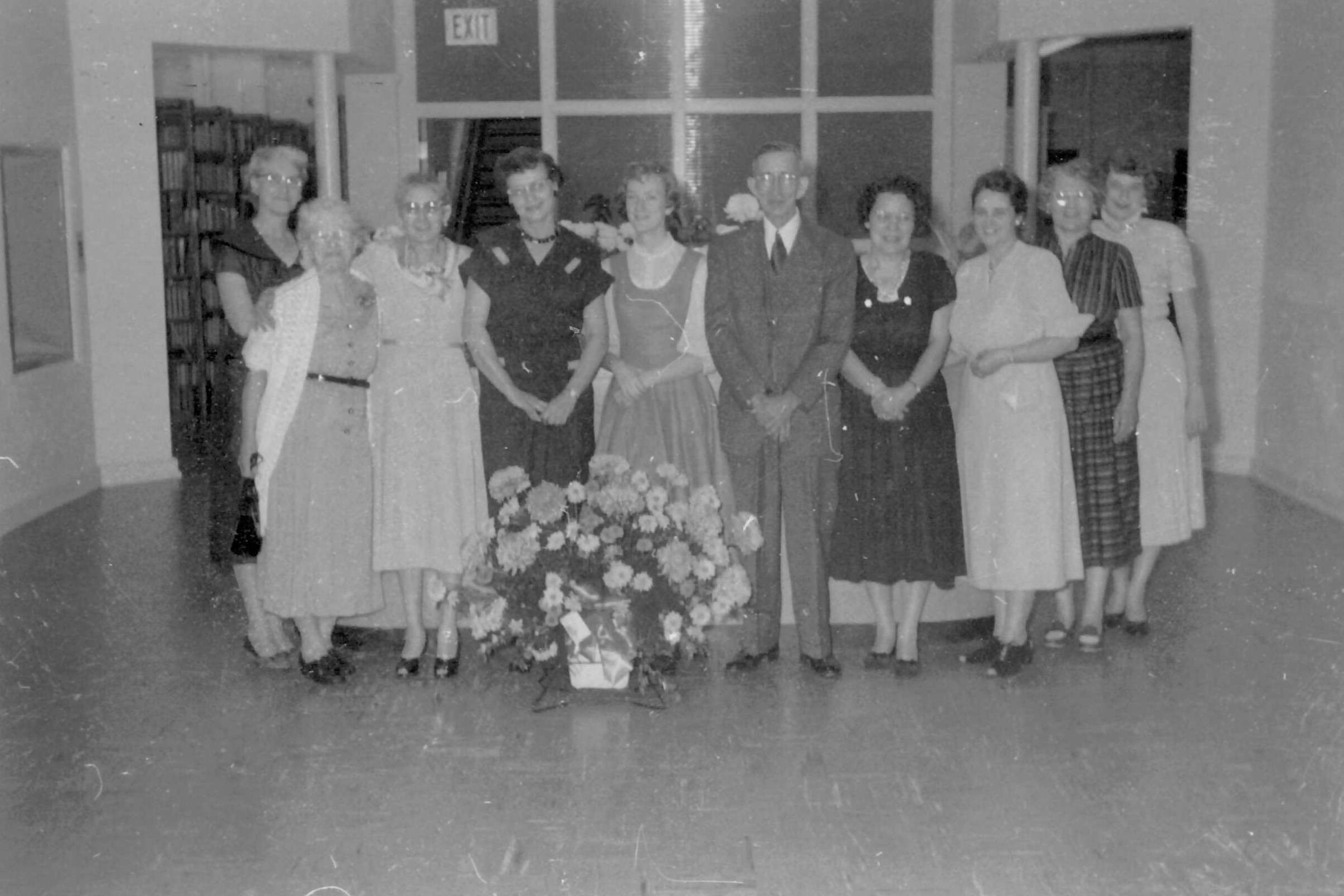 Librarians celebrating the new library in dresses and suits.