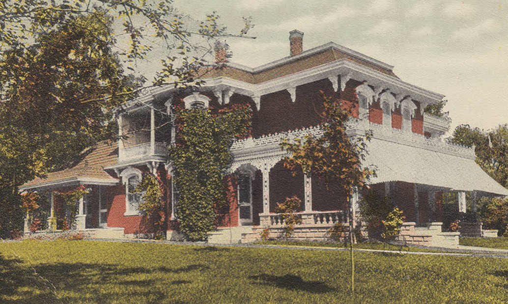 An old postcard of the Carter House, white shutters with red brick.